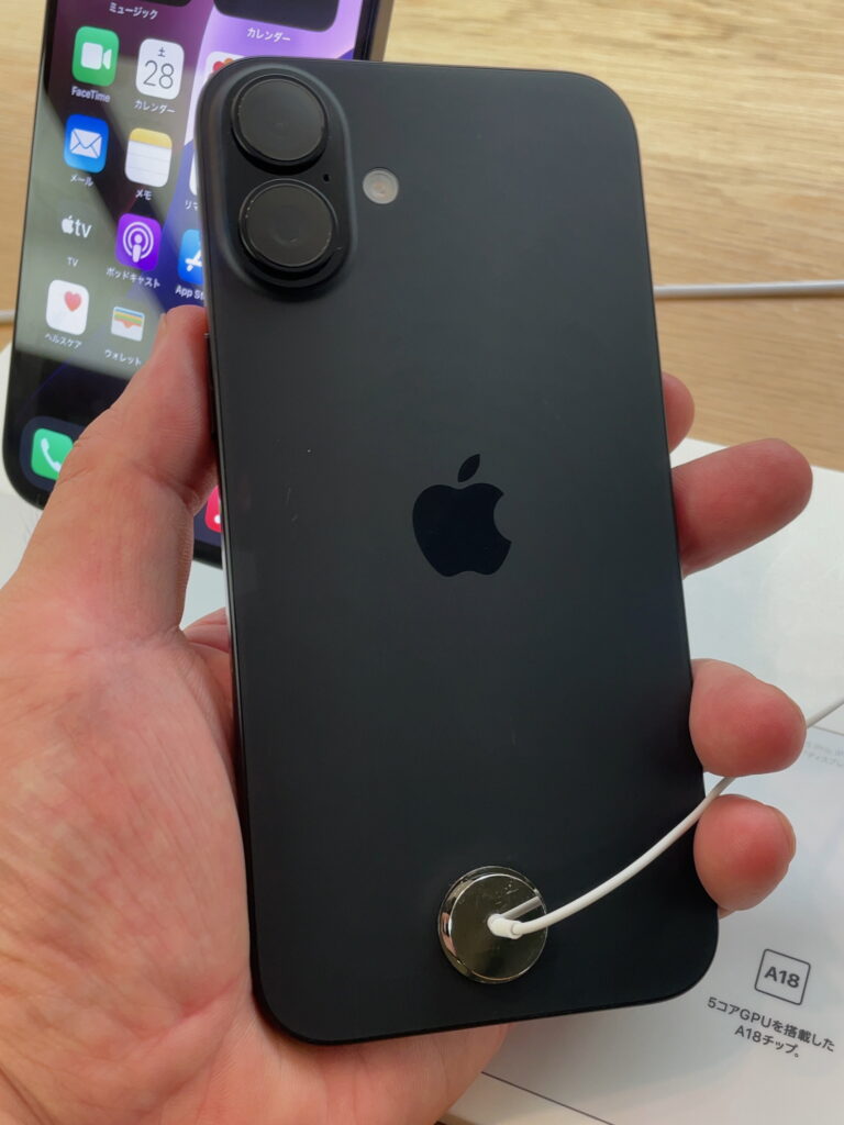 Apple iPhone 16 in India: Complete 2026 Buying Guide 2 High-resolution rear view of an Apple iPhone 16 in black, photographed at an Apple Store